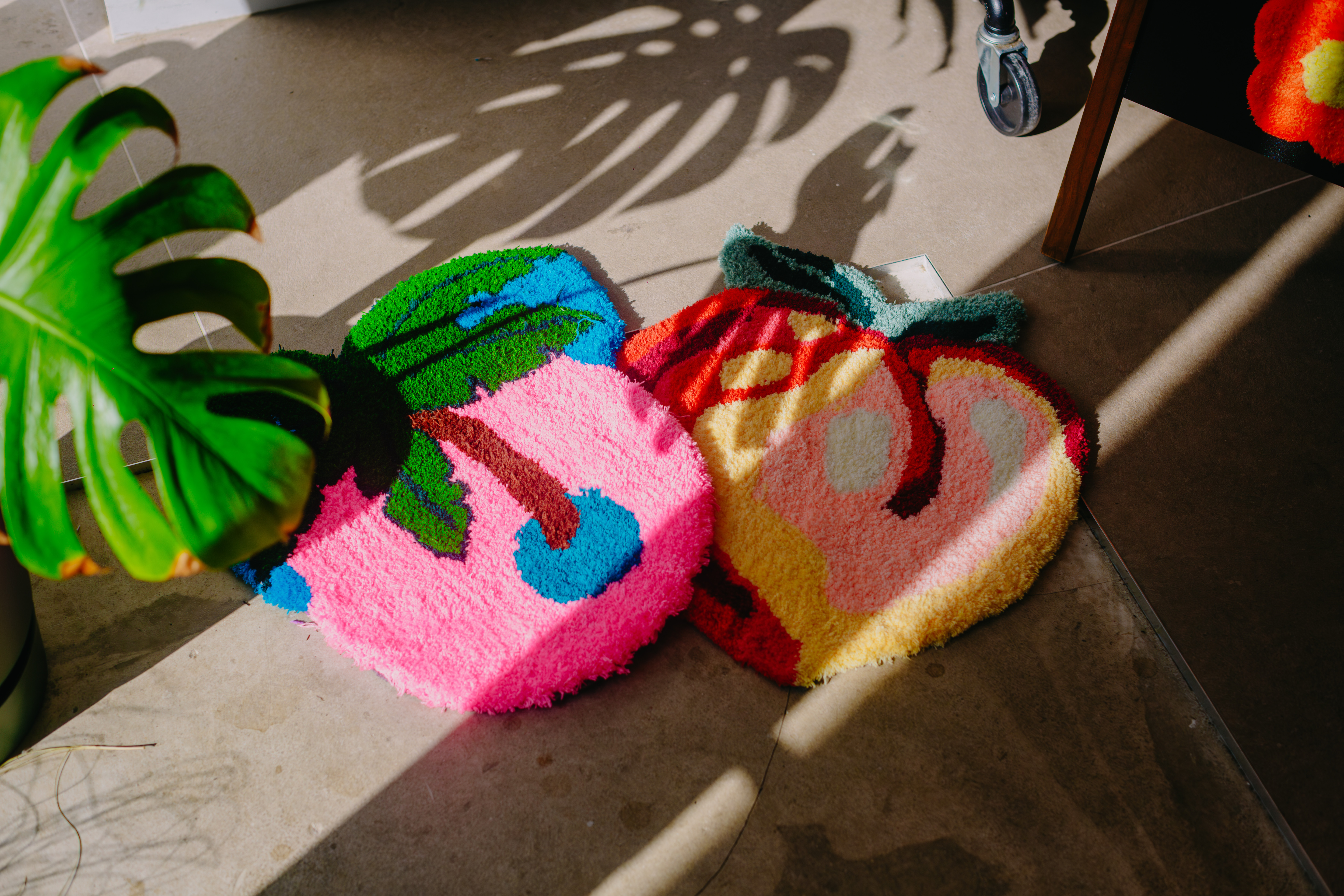 Two small tufted rugs on polished concrete floor in the sun
